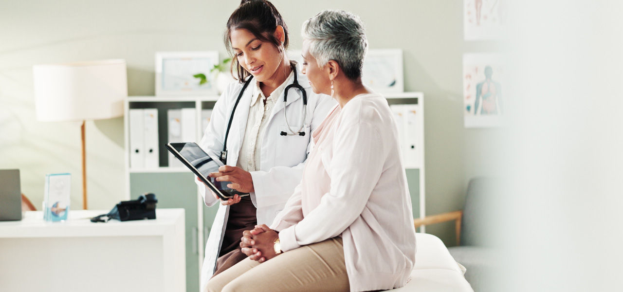 woman at doctor visit looking at electronic chart.